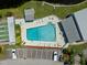 Overhead shot of community pool with convenient parking, shuffleboard, and surrounding landscaping at 2212 Lark W Cir # E, Palm Harbor, FL 34684