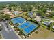Aerial view of the community tennis courts and residential homes at 2212 Lark W Cir # E, Palm Harbor, FL 34684