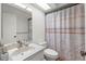 Bathroom featuring a sink with modern faucet, toilet, and shower with patterned curtain at 2212 Lark W Cir # E, Palm Harbor, FL 34684