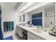 Bright bathroom featuring a long double sink vanity with modern fixtures and neutral color scheme at 2212 Lark W Cir # E, Palm Harbor, FL 34684