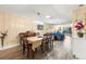 Bright dining area featuring hardwood floors, modern chandelier, and an open floor plan at 2212 Lark W Cir # E, Palm Harbor, FL 34684