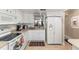 Clean kitchen with white appliances and cabinets at 2212 Lark W Cir # E, Palm Harbor, FL 34684