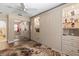 Spacious main bedroom featuring built-in closet with lighted display shelves and ceiling fan at 2212 Lark W Cir # E, Palm Harbor, FL 34684