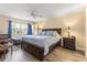 Serene main bedroom with a ceiling fan and hardwood floors at 2212 Lark W Cir # E, Palm Harbor, FL 34684