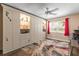 Charming main bedroom with built-in cabinets with display shelves, ceiling fan, and window at 2212 Lark W Cir # E, Palm Harbor, FL 34684