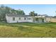 Expansive backyard with lush green lawn and a covered patio, perfect for outdoor entertaining at 2288 Cheryl Rd, Largo, FL 33771