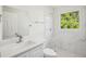 Bathroom featuring marble tile, modern fixtures, and a bright window view at 2288 Cheryl Rd, Largo, FL 33771