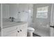 Bright bathroom with modern vanity and hardware, shower with glass and white marble tile at 2288 Cheryl Rd, Largo, FL 33771