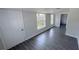 Bright bedroom with gray floors, white door and trim, and large windows with outdoor views at 2288 Cheryl Rd, Largo, FL 33771