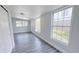Bright bedroom showcasing gray laminate flooring and large windows letting in lots of natural light at 2288 Cheryl Rd, Largo, FL 33771