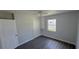 Bedroom featuring hardwood floors, one window, a ceiling fan, a closet and a light gray paint at 2288 Cheryl Rd, Largo, FL 33771
