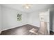 A bright bedroom featuring a large window, neutral walls, and the new flooring throughout at 2288 Cheryl Rd, Largo, FL 33771