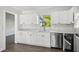 Updated kitchen features stainless steel appliances, stone countertops, and bright white cabinets at 2288 Cheryl Rd, Largo, FL 33771