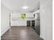Bright kitchen with stainless steel appliances, wood floors and white cabinets at 2288 Cheryl Rd, Largo, FL 33771