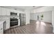 Modern kitchen with stainless steel appliances, white cabinets, and wood-look flooring at 2288 Cheryl Rd, Largo, FL 33771