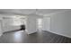 Bright living room showing new flooring and an entrance to a white kitchen with stainless appliances at 2288 Cheryl Rd, Largo, FL 33771