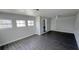 Bright living space with new flooring featuring multiple windows and a view into other rooms at 2288 Cheryl Rd, Largo, FL 33771