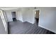 Open living area featuring gray plank floors, white trim and doorways to other rooms in the home at 2288 Cheryl Rd, Largo, FL 33771