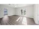 Expansive open-plan living area featuring new floors and natural light from the double doors at 2288 Cheryl Rd, Largo, FL 33771