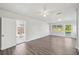 Spacious living room featuring large windows, ceiling fan, and new flooring at 2288 Cheryl Rd, Largo, FL 33771