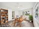 Bright staged office with a large window, bookcase, neutral walls, and light wood desk at 2288 Cheryl Rd, Largo, FL 33771