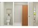 Bright bathroom with a shower stall, modern fixtures, decorative shower curtain and neutral wall art at 2291 Blue Grosbeak Pl, Wimauma, FL 33598