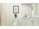 Fresh bathroom with white cabinets, a shower with a curtain, and neutral decor, offering a clean and serene space at 2291 Blue Grosbeak Pl, Wimauma, FL 33598