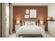 Cozy bedroom with plush bedding, side tables with lamps, and a warm color palette for a relaxing retreat at 2291 Blue Grosbeak Pl, Wimauma, FL 33598
