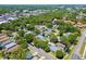 A bird's eye view of a charming home surrounded by lush greenery in a suburban neighborhood at 2486 Hickman Cir, Clearwater, FL 33761