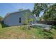 The side and back yards feature a brick patio area, mature trees, and a partial perimeter fence at 2486 Hickman Cir, Clearwater, FL 33761