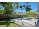 Spacious backyard with brick paver patio, wooden fence and mature trees for added privacy at 2486 Hickman Cir, Clearwater, FL 33761