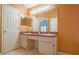 Bathroom with double sink vanity, large mirror and doorway visible at 2486 Hickman Cir, Clearwater, FL 33761