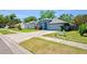 Street view showcasing a well-maintained, light blue single-Gathering home with an attached garage at 2486 Hickman Cir, Clearwater, FL 33761