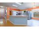 Bright kitchen features an island, stainless steel refrigerator, and a view to the yard at 2486 Hickman Cir, Clearwater, FL 33761