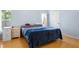 Main bedroom offers a bright window, neutral paint, and wood floors at 2486 Hickman Cir, Clearwater, FL 33761