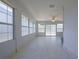 Bright sunroom featuring tile floors, multiple windows, and glass sliding doors to bring the outdoors in at 2486 Hickman Cir, Clearwater, FL 33761