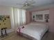 Main bedroom with ceiling fan, large window, pink built-in storage, and neutral carpet at 2618 Cove Cay Dr # 403, Clearwater, FL 33760