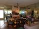 Dining room with chandelier, mirrored wall, tile floors, and view into kitchen area at 2618 Cove Cay Dr # 403, Clearwater, FL 33760