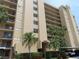 Exterior shot of condo building showing palm trees, building address, and covered parking at 2618 Cove Cay Dr # 403, Clearwater, FL 33760