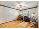 Bright bedroom featuring hardwood floors, shutters, and a ceiling fan at 2932 Chelsea Woods Dr, Valrico, FL 33596