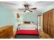 Cozy bedroom boasts hardwood floors, closet space, and a ceiling fan at 2932 Chelsea Woods Dr, Valrico, FL 33596