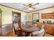 Charming dining room features a round wooden table, hardwood floors, and ample seating at 2932 Chelsea Woods Dr, Valrico, FL 33596
