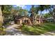 Charming front exterior of the home, complemented by a green lawn and mature trees at 2932 Chelsea Woods Dr, Valrico, FL 33596