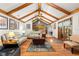 Bright living room with beamed vaulted ceiling, hardwood floors, and stylish furnishings, creating a welcoming atmosphere at 2932 Chelsea Woods Dr, Valrico, FL 33596