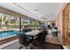 Enclosed patio featuring a dining table, seating, and a view of the pool at 2932 Chelsea Woods Dr, Valrico, FL 33596