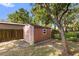 Backyard shed for storage and outdoor equipment, surrounded by trees and landscaping at 2932 Chelsea Woods Dr, Valrico, FL 33596