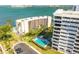 Exterior shot of white condo buildings and an inviting community pool with lounge chairs at 30 Turner St # 604, Clearwater, FL 33756