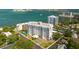 Waterfront condominium with multiple balconies, lush landscaping, and a convenient circular driveway at 30 Turner St # 604, Clearwater, FL 33756