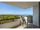 Balcony view with two chairs overlooking the water and trees at 30 Turner St # 604, Clearwater, FL 33756