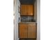 Close up of bar area with marble counters, wine glass rack, and cabinets at 30 Turner St # 604, Clearwater, FL 33756
